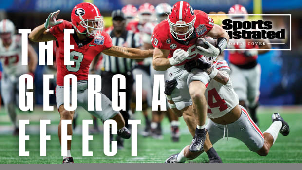 Georgia’s Brock Bowers barrels through the Ohio State defense.